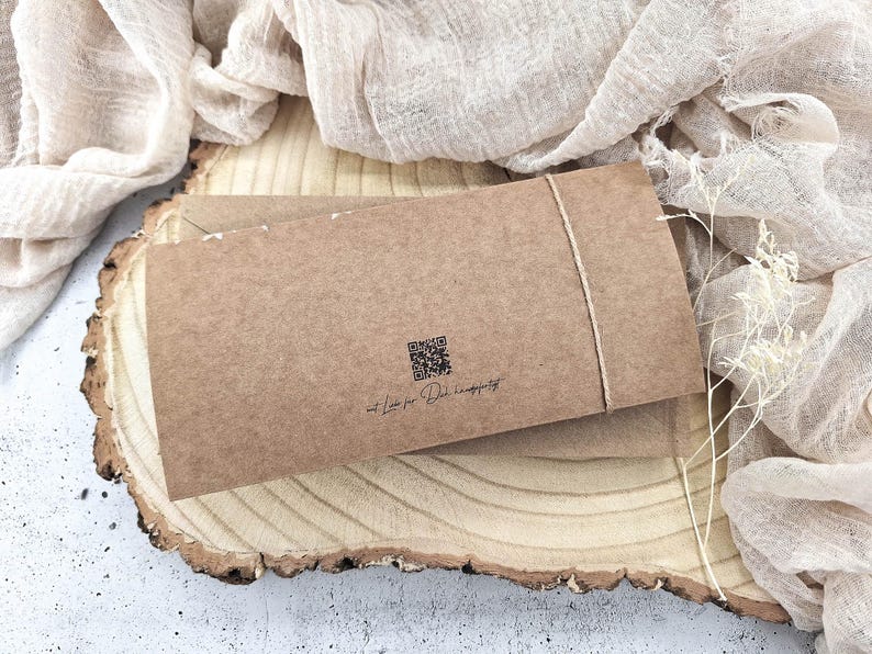 May include: A brown paper envelope with a string tied around it. The envelope has a QR code and the text "at Love for the Handmade" printed on it.