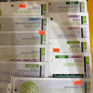 May include: A collection of white and light green quilting pattern instruction sheets from Cut Loose Press. Titles include Butter Cream Cupcake, Baby Steps, Half Log Cabin, Lickety Split Log Cabin, Set of 6 Hexie Placemats, Nested Gems, Woven Jewel Box, Twisted Peppermint, Tidepools, Raspberry Stars, and Courthouse Steps.