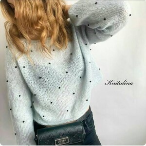 May include: A light blue knitted jumper with black beads throughout. The jumper has a relaxed fit and a slightly cropped length. The jumper is worn with black jeans and a black belt.