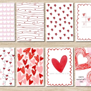 Op de afbeelding: Een verzameling Valentijnskaarten met verschillende ontwerpen. Sommige kaarten tonen herhaalde hartpatronen, terwijl andere handgetekende harten, lijnen en de tekst "Happy Valentine's Day!" in het rood hebben. De kaarten zijn rechthoekig met witte achtergronden.