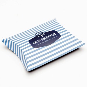 May include: A blue and white striped pillow box with a logo that says "OLD SKIPPER - for sea lovers" and a nautical wheel graphic.