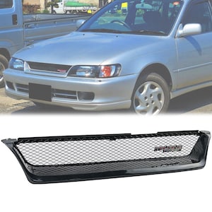 May include: Black aftermarket grille with a mesh design and "Exclusive Parts" text in red. The grille is designed to fit a 1993-1997 Toyota Corolla.