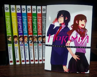 May include: A set of manga books from the "Horimiya" series. The spines are in various colours, with volume numbers clearly displayed. The first volume is shown, with two anime characters and the title "Horimiya."