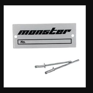May include: A silver metal nameplate with the word "monster" printed in black. The nameplate has a blank space for a number with the text "No." printed above it. Two silver metal rivets are included.