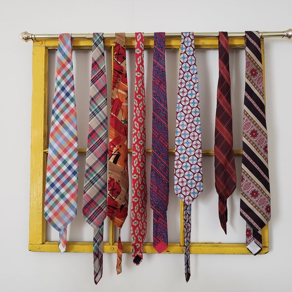 Assorted age vintage neckties plaid, abstract, and paisley, cotton, silk, and synthetic, red, brown, orange, yellow, warm tones