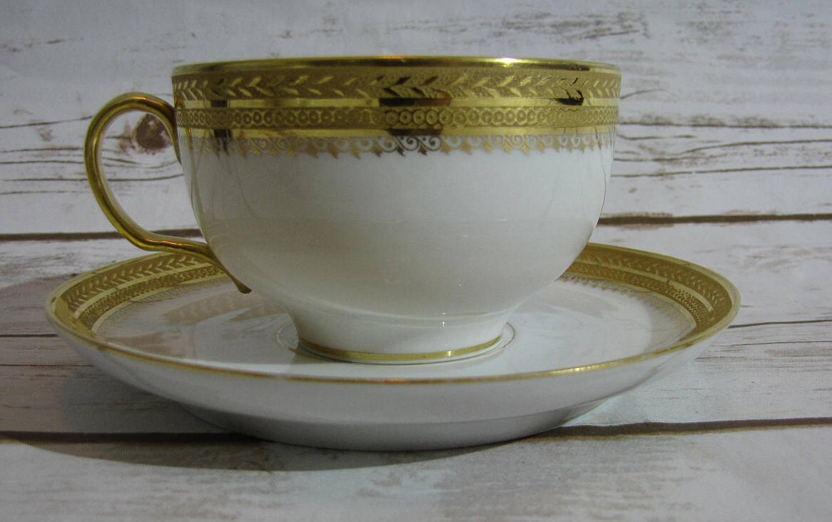 W Guerin & Co White Two Handles Porcelain Teacup and Saucer With Gold Trim  