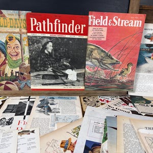 May include: A collection of vintage magazines and ephemera. Magazines include "Pathfinder" and "Field & Stream." The "Field & Stream" cover features a fish and duck illustration. Other items include pages with illustrations and text, and a magazine titled "Good Old Days."