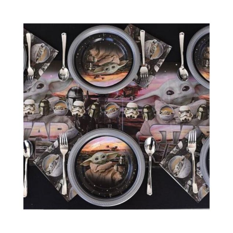 May include: A Star Wars-themed party table setting with plates, napkins, and cutlery. The plates feature an image of Grogu, also known as Baby Yoda, with a silver rim. Napkins and a table runner display Star Wars characters.