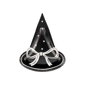 May include: A black witch hat-shaped party plate with a white bow and star accents. The plate has a scalloped edge and is designed for Halloween or themed parties.