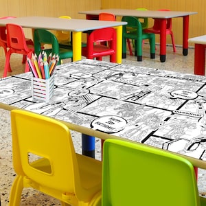 May include: A black and white coloring table cloth with a comic book theme featuring robots and the text "Happy 1st Birthday!" and "Transformers".