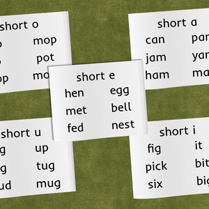 May include: White cards with black text showing short vowel sounds and words with those sounds. The words are "short o", "pop", "mop", "job", "pot", "shop", "mo", "short a", "can", "pan", "jam", "yam", "ham", "man", "short e", "hen", "egg", "met", "bell", "fed", "nest", "short u", "bug", "up", "dug", "tug", "mud", "mug", "short i", "fig", "it", "pick", "bit", "six", "big".