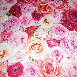 May include: A close-up of a floral pattern dominated by roses in shades of pink, red, and white. The roses are densely packed, creating a rich and romantic visual. The image highlights the full bloom of the flowers, showcasing their intricate details.