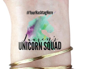 May include: A temporary tattoo with a watercolor unicorn design and the text "Lauren's Unicorn Squad" and the hashtag "#YourHashtagHere".
