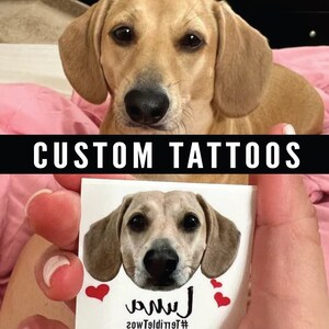 May include: A custom pet portrait tattoo featuring a dog's head with the name "Luna" written below. The tattoo is on a white background with red hearts.