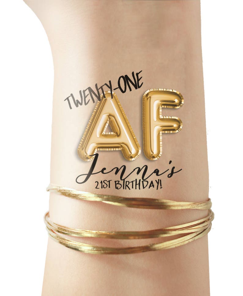 May include: Gold balloon letters spelling "AF" with the text "Twenty-One" and "Jenna's 21st Birthday!" on a person's wrist.