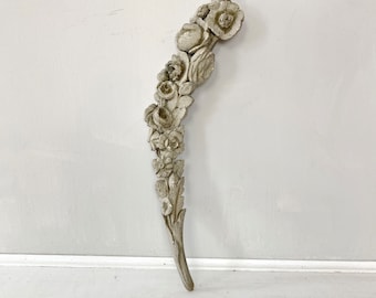 May include: White painted wooden floral design with a curved shape. The design features a series of carved roses and leaves.