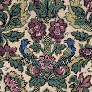 May include: A close-up of a fabric with a repeating pattern of birds, flowers, and leaves. The fabric is a cream color with green, blue, and pink accents.