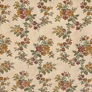 May include: A beige fabric with a repeating pattern of brown, yellow, and pink floral sprigs. The fabric has a subtle texture.
