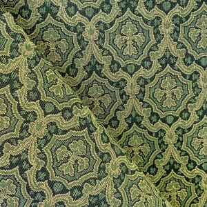 May include: Green and beige fabric with a repeating geometric pattern. The fabric has a textured surface.