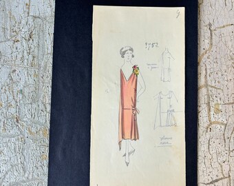 May include: A hand-drawn illustration of a woman wearing a pink dress with a flower on the shoulder. The illustration is on a piece of paper with the text "91*52" and "che" written on it.