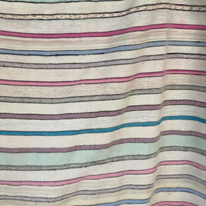 May include: A white fabric with horizontal stripes in various colors, including pink, blue, gray, and green.