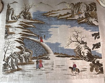 May include: A fabric panel featuring a landscape scene with a bridge, river, and mountains. The design includes figures in traditional clothing, trees, and a rider on horseback. The color palette includes shades of blue, beige, and gold.