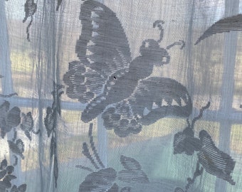May include: White sheer curtain with a delicate embroidered butterfly design.