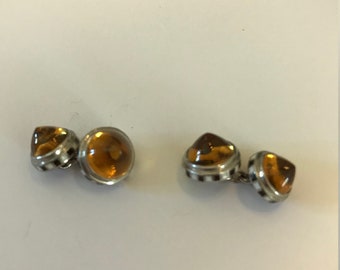 A pair of silver and smoky topaz cufflinks decorated with black and white enamel