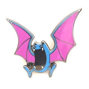 May include: A blue and pink enamel pin featuring a cartoon bat Pokemon with a wide open mouth. The bat has pink wings and a blue body.
