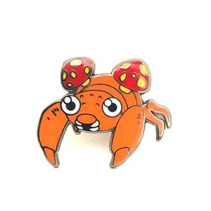 May include: Orange and red cartoon crab with two mushroom-shaped shells on its head.