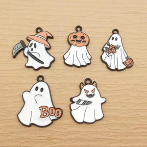 May include: Five Halloween-themed charms with black outlines. The charms feature white ghosts with various designs, including a pumpkin head, a grim reaper, and the word "Boo". Each charm has a small loop at the top for attaching to jewelry or other crafts.