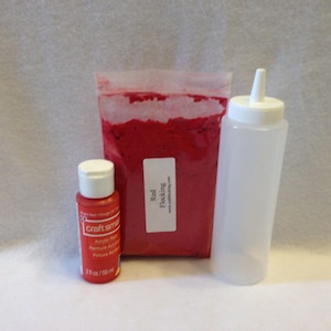 May include: A set of red craft supplies including a bottle of red acrylic paint, a bag of red flocking, and a clear plastic squeeze bottle.