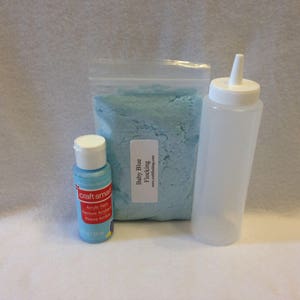 May include: A bag of baby blue flocking, a bottle of blue acrylic paint, and a clear plastic squeeze bottle.