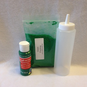 May include: A clear plastic squeeze bottle, a small bottle of green acrylic paint, and a bag of green flocking. The flocking bag has the text "Green Flocking" and a website address.