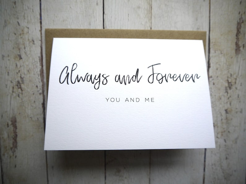 May include: White card with black calligraphy that reads "Always and Forever" and "You and Me".