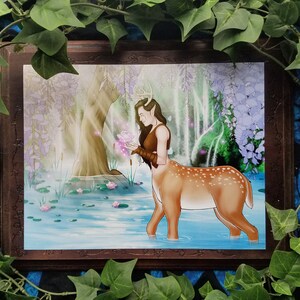May include: A painting of a deer-like creature with antlers and human-like features standing in a pond. The creature is holding a pink flower and is surrounded by water lilies. The background is a lush forest with a waterfall.