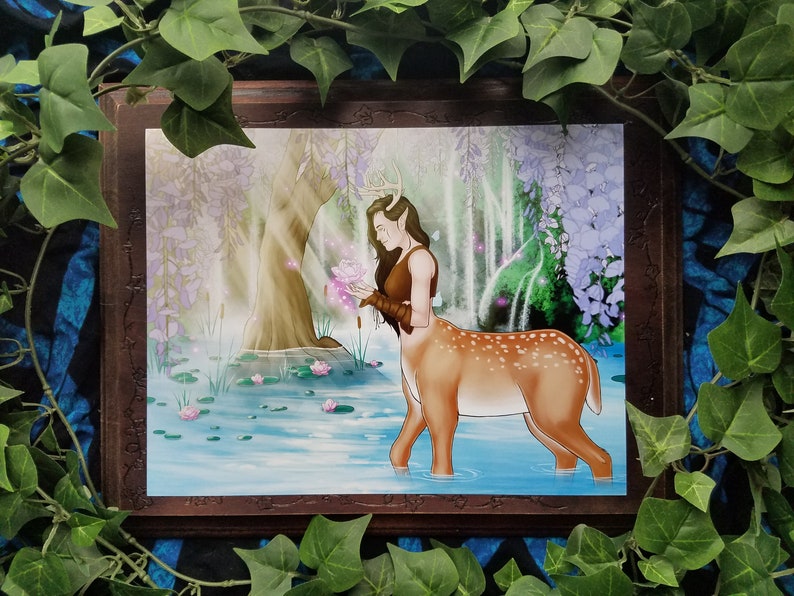 May include: A painting of a deer-like creature with antlers and human-like features standing in a pond. The creature is holding a pink flower and is surrounded by water lilies. The background is a lush forest with a waterfall.