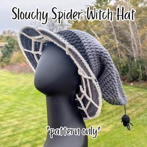 Puede incluir: Un sombrero de bruja de ganchillo gris con un diseño de telaraña en el borde. El sombrero tiene un estilo holgado y un pequeño amuleto de araña negra colgando de la punta. El texto de la imagen dice "Slouchy Spider Witch Hat" y "pattern only".
