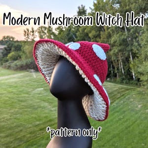 May include: A red and white crochet mushroom witch hat with a wide brim and white polka dots. The hat is displayed on a black mannequin head against a green background. The text "Modern Mushroom Witch Hat" and "pattern only" are visible.