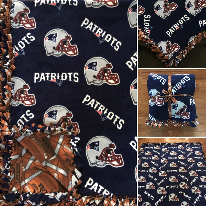 May include: A blue fleece blanket with a football helmet and the word "Patriots" repeated throughout. The blanket is tied with a brown ribbon and has a brown and white football pattern on the reverse side.