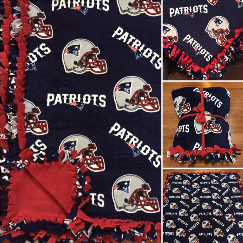 May include: A red and blue fleece tie blanket with the word "Patriots" repeated throughout the fabric. The blanket is tied together with red ribbon.