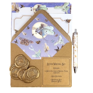May include: A letter writing set featuring illustrated paper, envelopes, and self-adhesive seals. The set includes a pen with a white and brown marble design. The envelope and paper feature a moth and moon design with a brown kraft paper envelope.