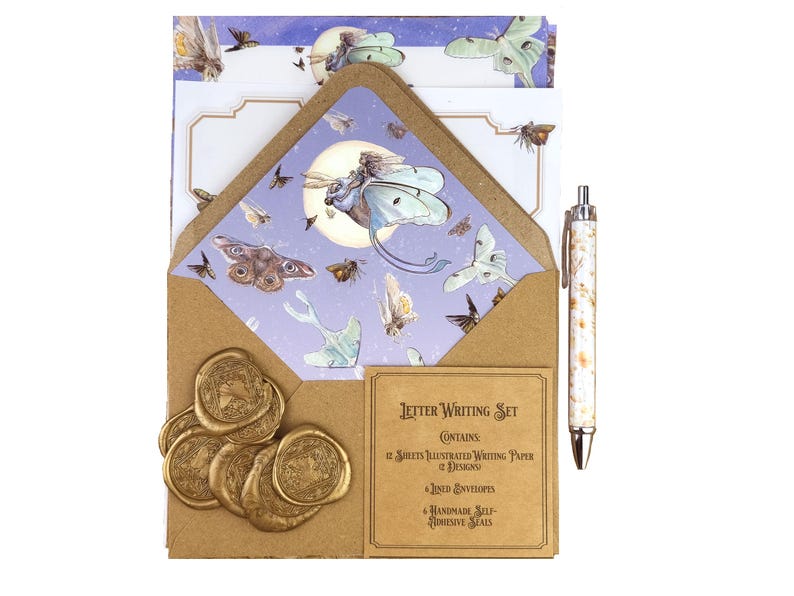 May include: A letter writing set featuring illustrated paper, envelopes, and self-adhesive seals. The set includes a pen with a white and brown marble design. The envelope and paper feature a moth and moon design with a brown kraft paper envelope.