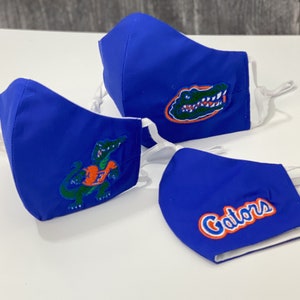 Embroidered Florida Gators Face Mask. 100% Cotton. 3 Layers. Metal Nose Bridge. Adjustable Elastic Ear Straps option. Made in the U.S.A.
