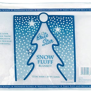 May include: A white snow fluff blanket in a clear plastic bag. The bag has a blue and white design with a Christmas tree and the text "Brite Star Snow Fluff Blanket 15 in. wide x 10 ft. long".