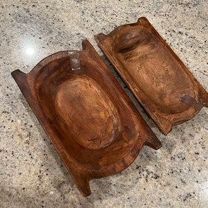 Lot of 2 Vintage Small Wooden Dough Bowls Euro Style Handles Repaired Rusty Patch Dimensions 11” long X 5 1/2” wide X 2” Hand Carved