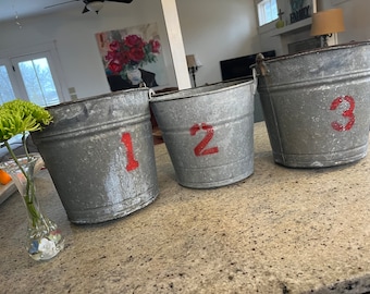 Lot of 3 Vintage Rustic Galvanized Tree Sap Maple Syrup Buckets  Dimensions  10” tall  X 11” wide  Numbered 1 2 & 3