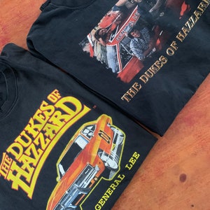Lote de 2 80s Vintage Dukes of Hazard camisetas ambos tamaño XL gráficos impresionantes hechos en EE.UU.