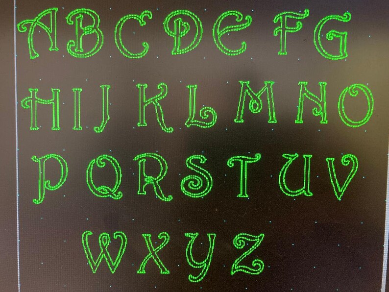 May include: A green alphabet with a decorative, cursive font. Each letter is outlined in green and has a black background.
