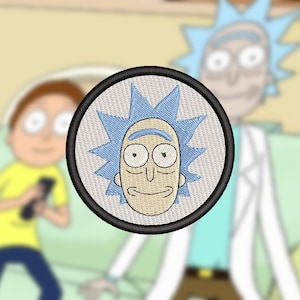 May include: Embroidered patch featuring a cartoon character with blue hair and a white face. The character is smiling and has large eyes. The patch is circular and has a black border.